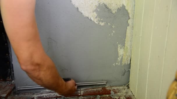 Man plastering with a spatula wall — Stock Video