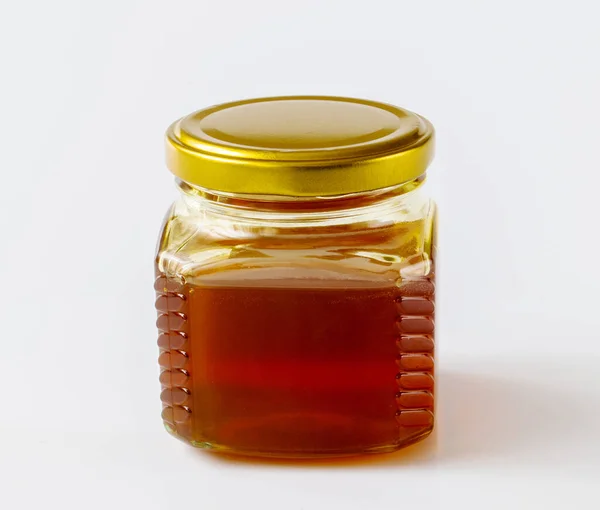 Méz Üveg Üveg Egy Könnyű Háttér — Stock Fotó