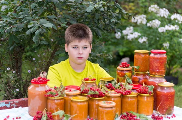 Boy and home canned vegetables in nature — Stock Photo, Image
