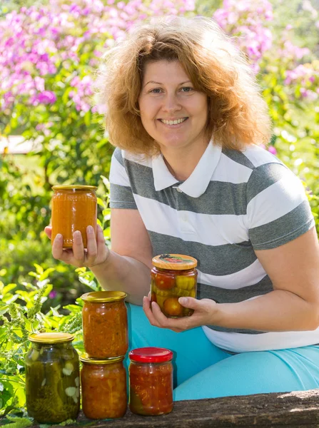 Housewife with a homemade preserves in  garden — Stock Photo, Image