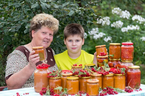 Grandmother and grandson with  homemade preserves — Stock Photo, Image