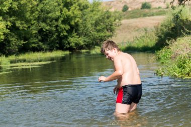 Full 10 years boy swim in  river clipart