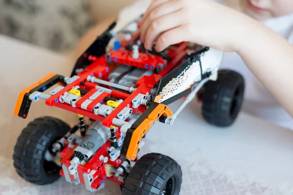 Boy plays collects from the constructor of  car — Stock Photo, Image