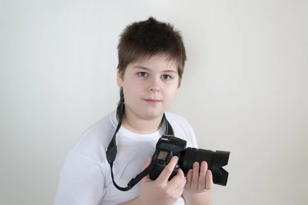 Teenage boy with camera on light — Stock Photo, Image