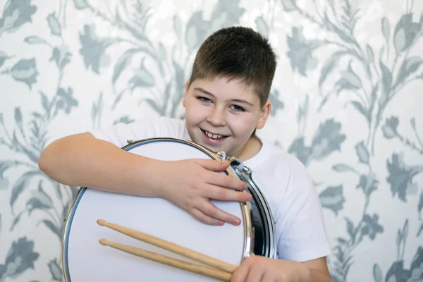 Teenager boy with a drum in  room — Stock Photo, Image