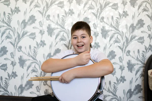 Teenager boy with a drum in  room — Stock Photo, Image