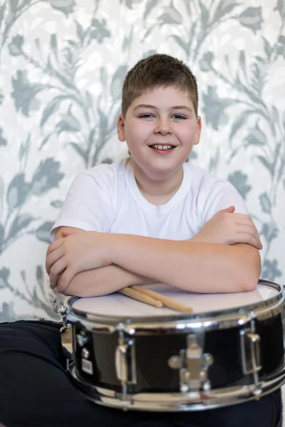 Мальчик-подросток с барабаном в комнате — стоковое фото