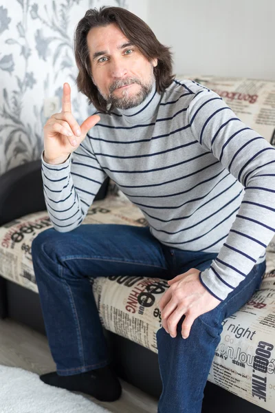 Man sitting on sofa in the room — Stock Photo, Image