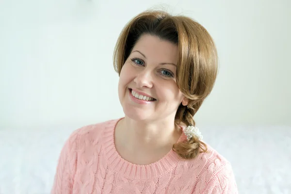 Portrait of positive woman in pink sweater — Stock Photo, Image