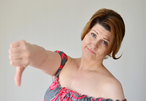 angry young woman showing thumb down