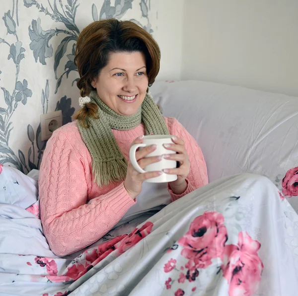 Woman with flu symptoms holding a cup in  hand — Stock Photo, Image