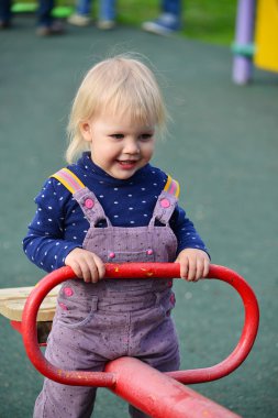  küçük kız açık salıncakta eğleniyor