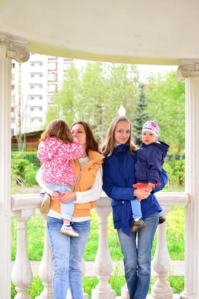 Two mothers with children on the walk in  gazebo — Stock Photo, Image