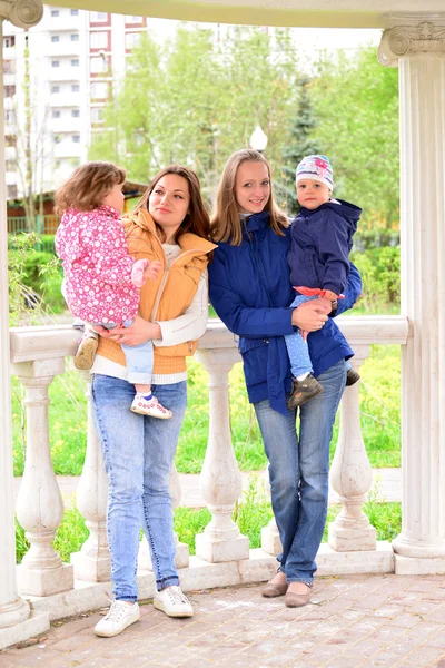 Two mothers with children on the walk in  gazebo — Stock Photo, Image