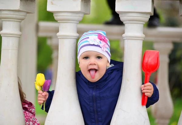 Two year old girl looks out from  gazebo — Stock Photo, Image