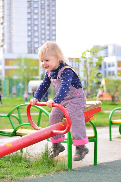 Little girl having fun on a swing outdoor — Stock Photo, Image