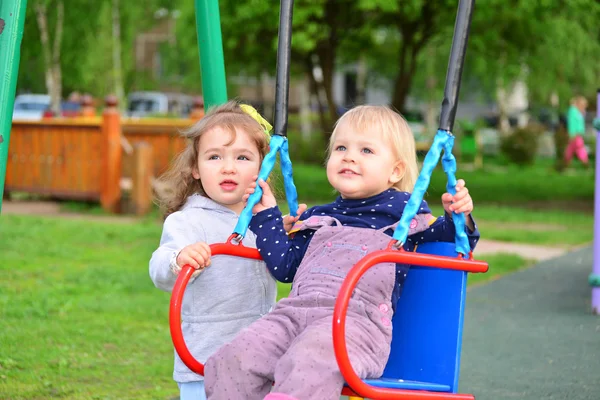 Two little girl on  swing ride — Stock Photo, Image