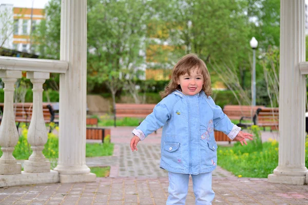 Cute baby girl with blonde curly hair outdoors.  2-3 year old. — Stock Photo, Image