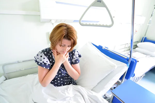 Female patient with angina on  bed in hospital ward — Stock Photo, Image