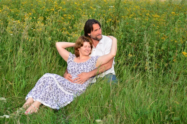 Çift bir çayır üzerinde rahatlatıcı sevgi dolu