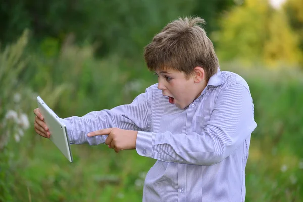 Teen pojke med tablet PC på natur — Stockfoto