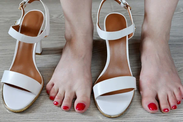 Womens legs and white sandals — Stock Fotó