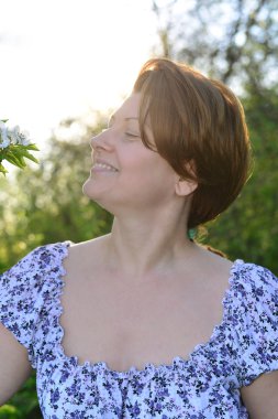 Awoman in  apple orchard at  early spring
