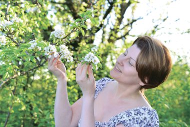 Awoman in  apple orchard at  early spring