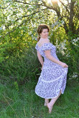 Awoman in  apple orchard at  early spring