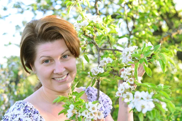 Una mujer en el huerto de manzanas a principios de primavera — Foto de Stock