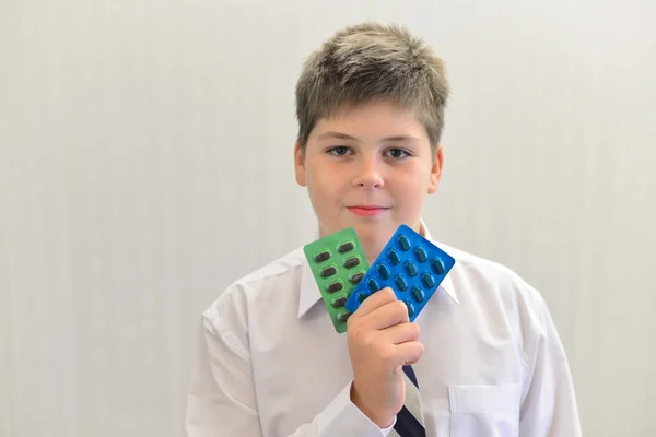 Teenage boy with the medicine in his hands — Stock Photo, Image