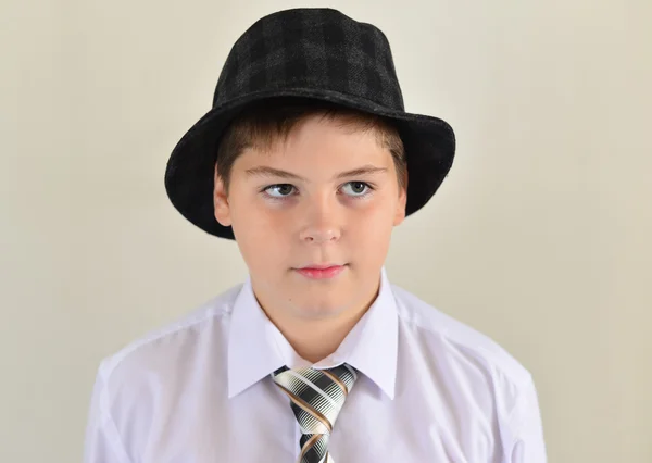 Portrait of a teenage boy in  hat and tie — Stock Photo, Image