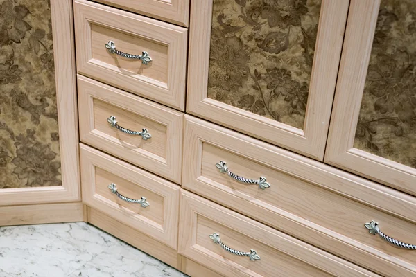 Fragment of beige cupboard with drawers — Stock Photo, Image