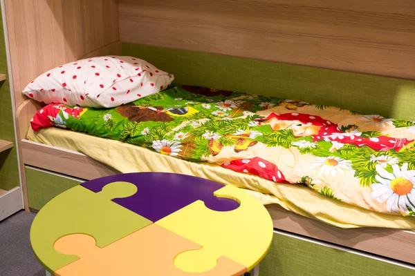 Fragment  interior children's room with a table in  form of  puzzle — Stock Photo, Image