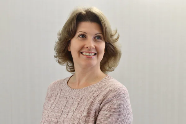 Portrait of  adult female on a light background — Stock Photo, Image