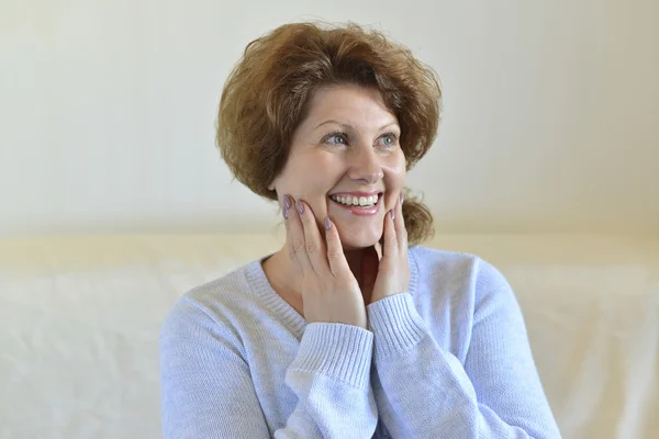 Woman dreaming sitting on a couch — Stock Photo, Image