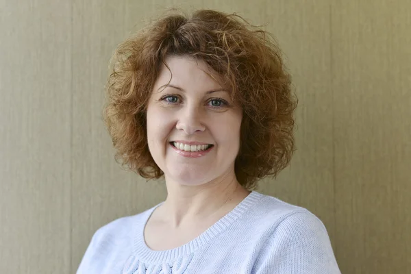 Portrait of  middle-aged woman with curly hair — Stock Photo, Image