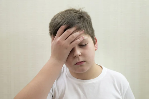 Portrait of  teenage boy with a headache — Stock Photo, Image