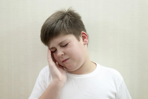 Portrait of  teenage boy with a headache — Stock Photo, Image