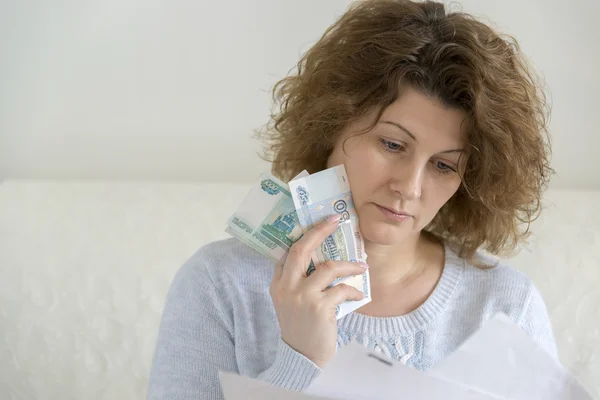 Adult woman with receipts and Russian money — Stock Photo, Image