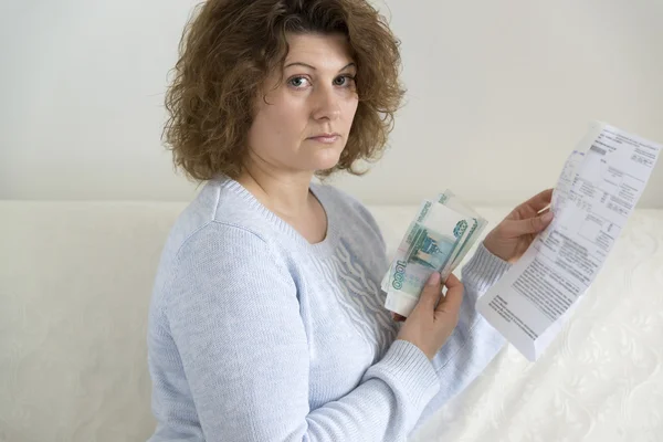 Adult woman with receipts and Russian money — Stock Photo, Image