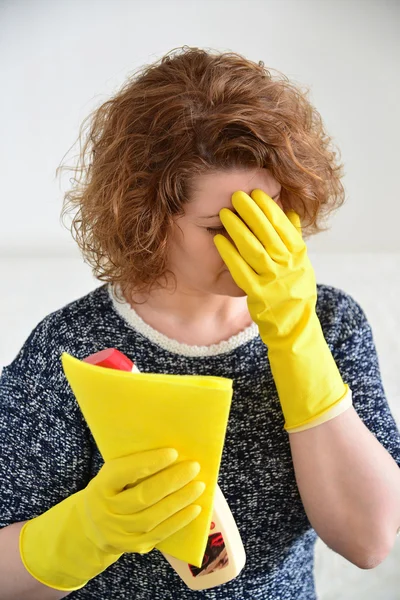 Woman with a headache after cleaning the house — Stock Photo, Image