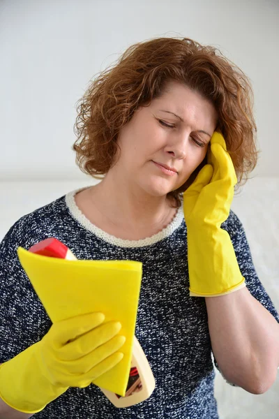 Woman with a headache after cleaning the house — Stock Photo, Image