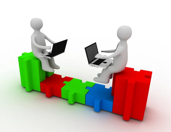 Two people with laptops sitting on puzzle pieces, are connected — Stock Photo, Image