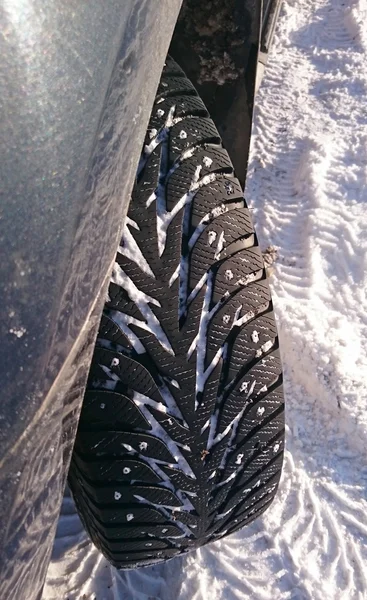 Tire on the winter street — Stock Photo, Image