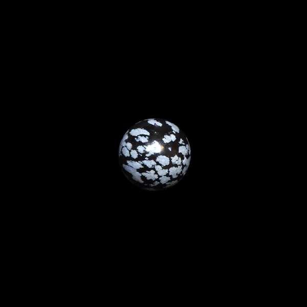 snow obsidian ball on black background