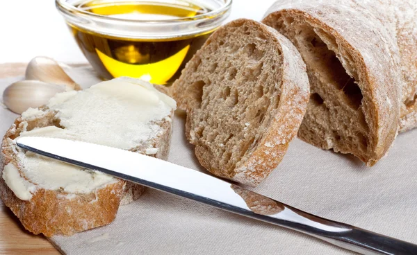 Fresh ciabatta with olive oil and butter — Stock Photo, Image