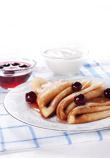 Pancakes with cherry jam and cherry and sour cream Stock Image