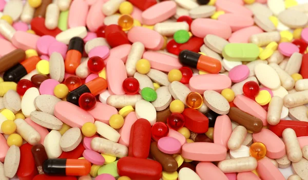 Lots of colorful tablets drug  and pills, medical background. Macro. — Stock Photo, Image