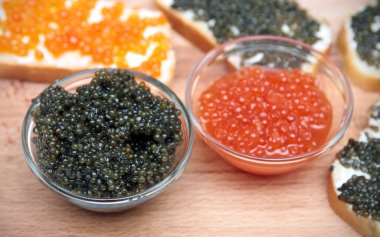 Black and red caviar in glass container clipart